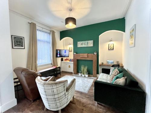 a living room with a couch and a fireplace at Modernised 3-bed home in Bamber Bridge, Preston in Bamber Bridge