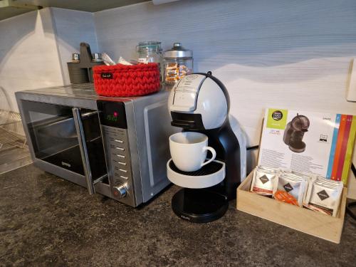 a coffee maker sitting next to a microwave at Veludo Apartments in Banská Bystrica