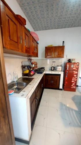 a kitchen with a sink and a refrigerator at Pumpkin eco villa in Tangalle