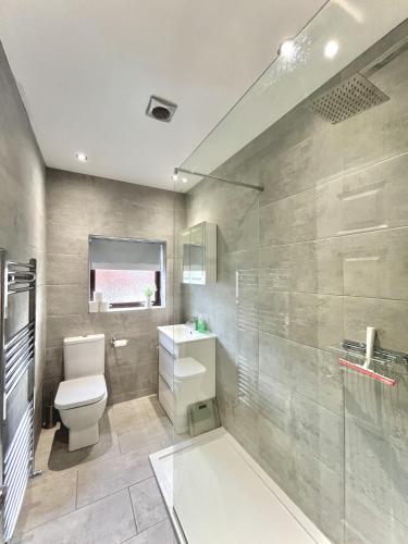 a bathroom with a toilet and a sink and a shower at Modernised 3-bed home in Bamber Bridge, Preston in Bamber Bridge
