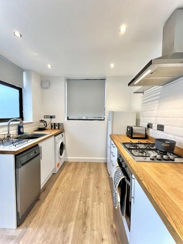 a kitchen with a sink and a stove top oven at Modernised 3-bed home in Bamber Bridge, Preston in Bamber Bridge