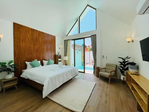 a bedroom with a large bed and a large window at Kaija Resort in Ko Larn