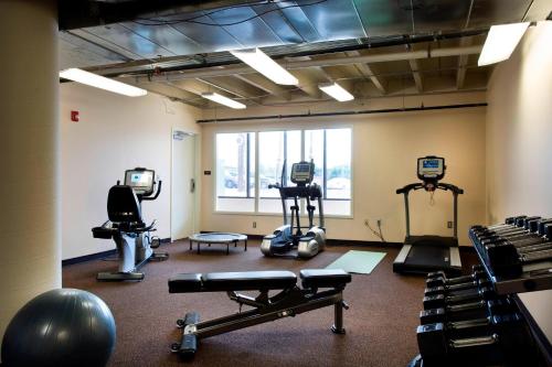 a gym with treadmills and exercise machines in a room at Ambassador Hotel Oklahoma City, Autograph Collection in Oklahoma City