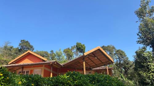 a house in the woods with a roof at Coorg hill in Somvārpet