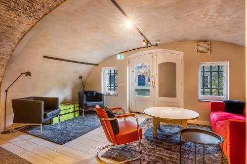 a living room with a couch and a table at Beautiful canal apartment in Utrecht for 4 persons in Utrecht