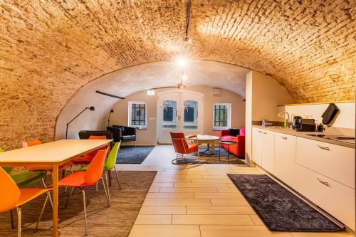 a kitchen and dining room with a brick wall at Beautiful canal apartment in Utrecht for 4 persons in Utrecht