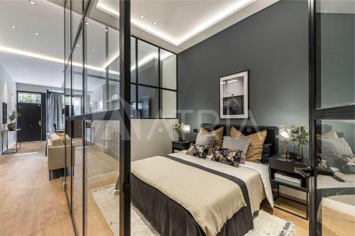 a bedroom with a bed and a glass wall at Designer apartment 2 in Madrid