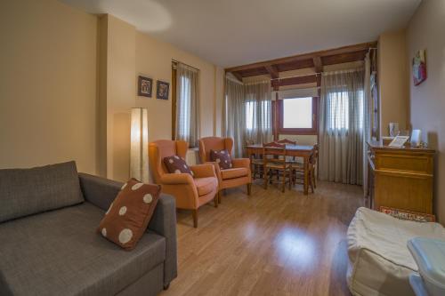 a living room with a couch and a dining room at Pleta de Soldeu D 4-3 in Soldeu