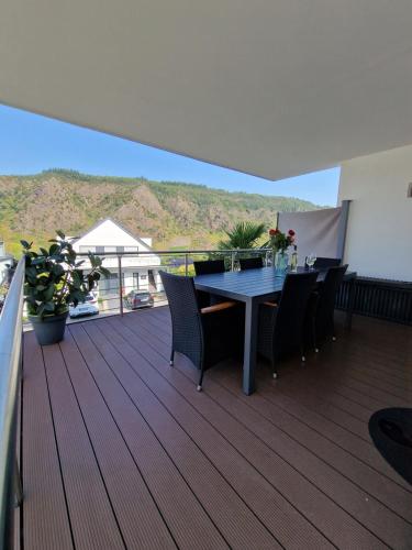 a balcony with a table and chairs on a deck at Ferienwohnungen Krause in Cochem