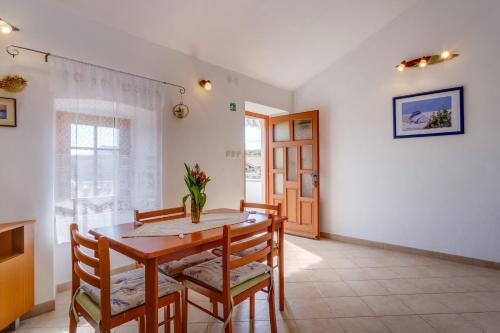 a dining room with a table and chairs at Apartman Maruči Stivan, Cres in Cres
