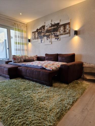 a living room with a leather couch and a rug at Ferienwohnungen Krause in Cochem