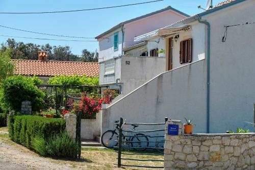 a bike is parked next to a building at Apartman Maruči Stivan, Cres in Cres