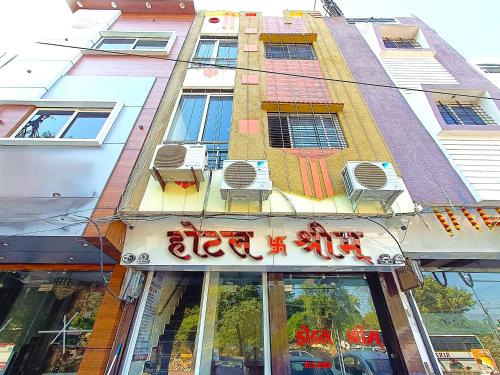 a building with chairs on the front of it at Hotel Shreem in Ujjain