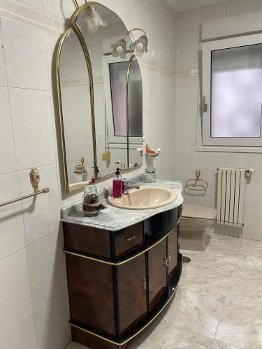 a bathroom with a sink and a mirror at Alojamiento CasAmalia in Santiago de Cartes