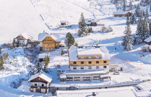 an aerial view of a resort in the snow at Planner Alpenhof in Planneralm