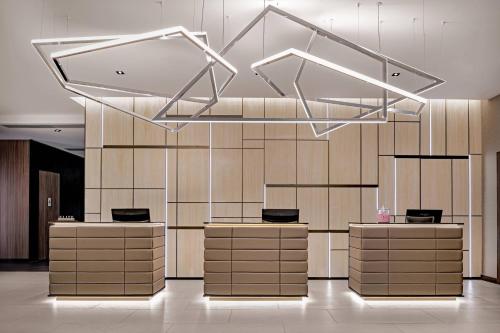 a lobby with a row of counters in a building at AC Hotel by Marriott Manchester City Centre in Manchester