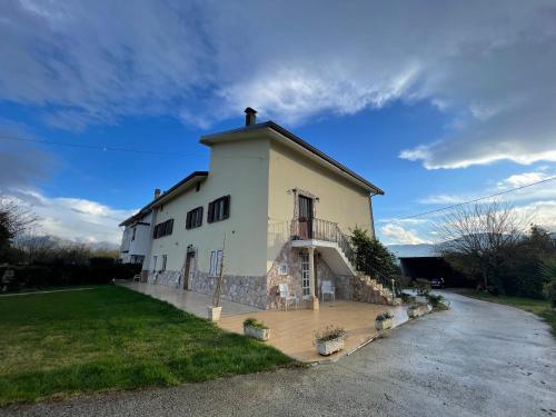 a large white building with a porch on a street at P&P nella natura in Cassino