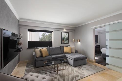 a living room with a couch and a table at Hotel Duval, Autograph Collection in Tallahassee