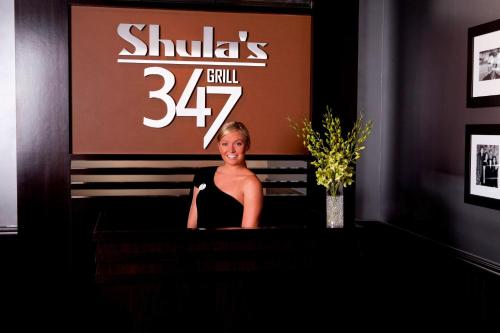 a woman sitting at a podium in front of a sign at Hotel Duval, Autograph Collection in Tallahassee