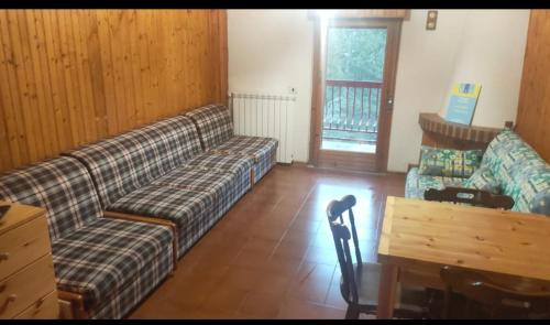 a living room with a couch and a table at Agrifoglio in Torre Caprara