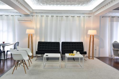 a living room with a couch and chairs and a table at Apollon Boutique Hotel in Parikia