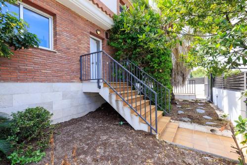 a house with a staircase next to a building at Villa Pla de l Era in Salou