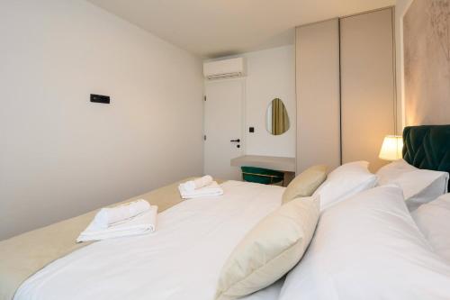 a bedroom with two beds with white pillows at 1st choice - spa apartment in Metković