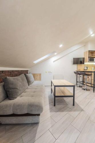 a living room with a couch and a table at CityApartments Kyiv Maidan in Kyiv