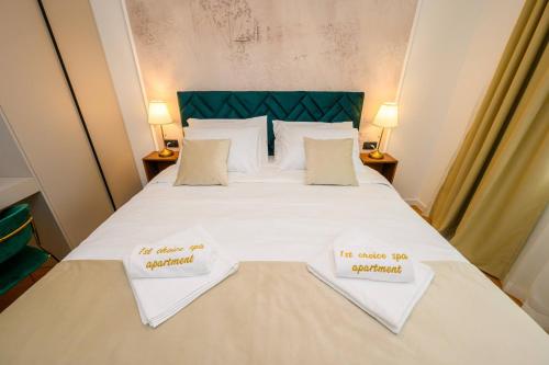 a bedroom with a bed with two towels on it at 1st choice - spa apartment in Metković