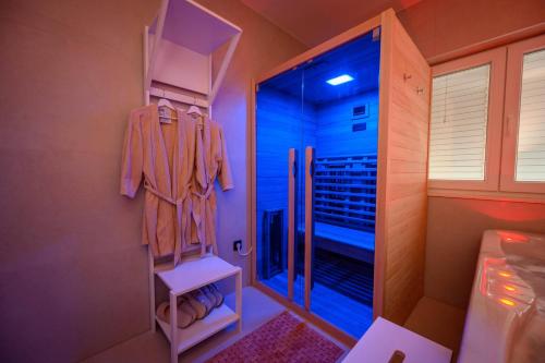 a bathroom with a walk in closet with a mirror at 1st choice - spa apartment in Metković
