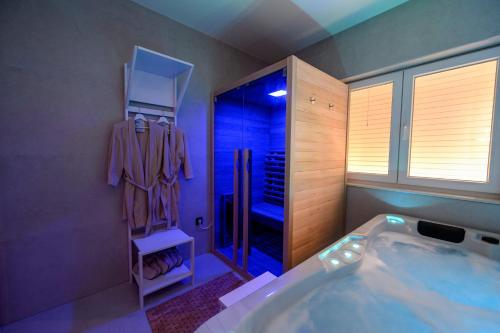 a bathroom with a tub and a walk in shower at 1st choice - spa apartment in Metković