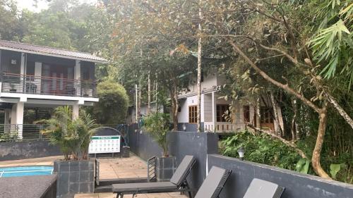 a view of a house with a swimming pool at B'camp Resorts & Homestays in Wayanad