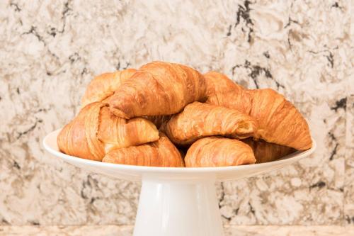 a white plate filled with croissants on a table at AC Hotel by Marriott Boston Cleveland Circle in Boston
