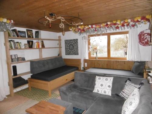a living room with a couch and a window at Mühlenwörth Relax Quartier in Tauberbischofsheim