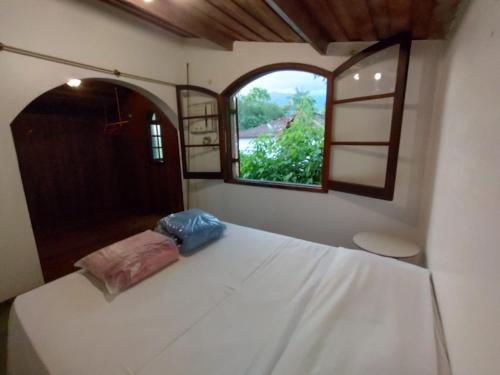 Ένα ή περισσότερα κρεβάτια σε δωμάτιο στο Casa da Cachoeira