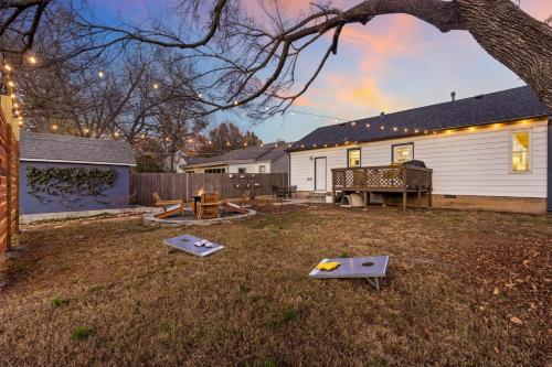 a backyard with a house and a table at Tulsa Expo Firepit Midtown House in Tulsa
