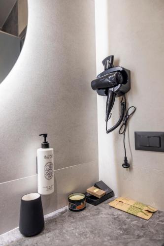 a phone is hanging on a wall in a bathroom at Polyzos Luxury Suites Meteora #2 - Adults Friendly in Kalabaka