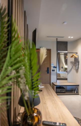 a living room with a table with a plant on it at Polyzos Luxury Suites Meteora #2 - Adults Friendly in Kalabaka