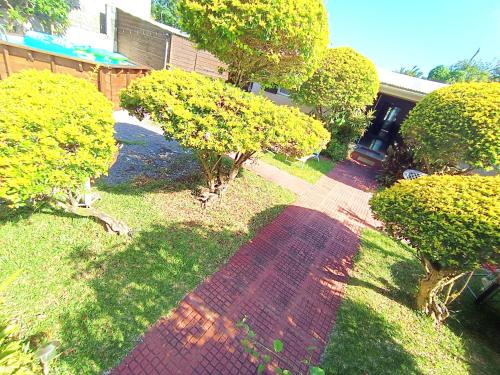 an overhead view of a walkway in a yard with trees at Chambre privée 1 - Case créole Le Mistral,chez Kévin in Saint-André