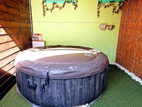 a large wooden barrel sitting in a corner of a room at Chambre privée 1 - Case créole Le Mistral,chez Kévin in Saint-André