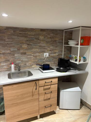 a kitchen with a sink and a counter at Appartamento indipendente al centro di Catania in Catania