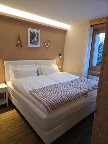 Postel nebo postele na pokoji v ubytování Dany Lodge Livigno