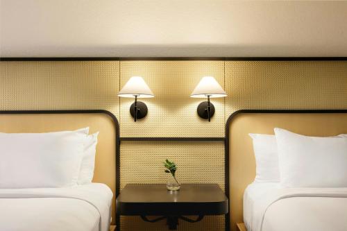 a hotel room with two beds and a table between them at Renaissance Boca Raton Hotel in Boca Raton