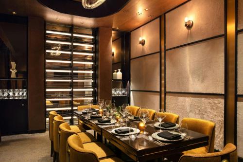 a dining room with a long table and chairs at Renaissance Boca Raton Hotel in Boca Raton