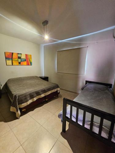 a bedroom with two beds in a room at Complejo Temporario Las Marias in San Juan