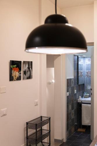 a large black light hanging over a bathroom at Casa Vahle in Dozza