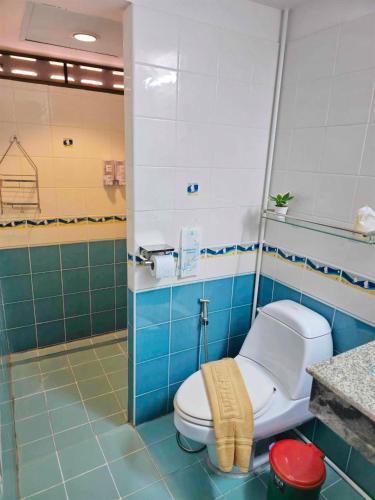 a bathroom with a toilet in a blue tiled room at Lanta MP Place in Ko Lanta