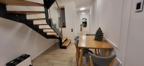 a hallway with a wooden table and a staircase at Anita's Mansion in Gattendorf
