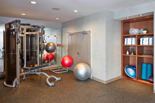 a room with a gym with balls and exercise equipment at AC Hotel by Marriott Des Moines East Village in Des Moines
