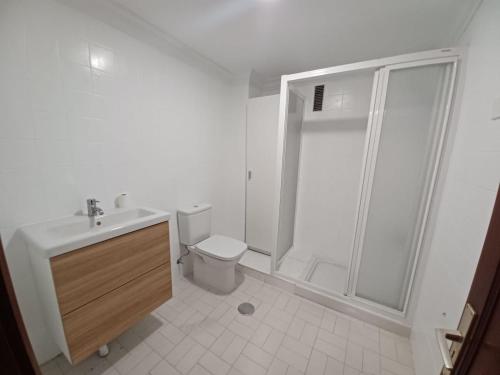 a white bathroom with a shower and a toilet at Vv La Marina in Santa Cruz de la Palma